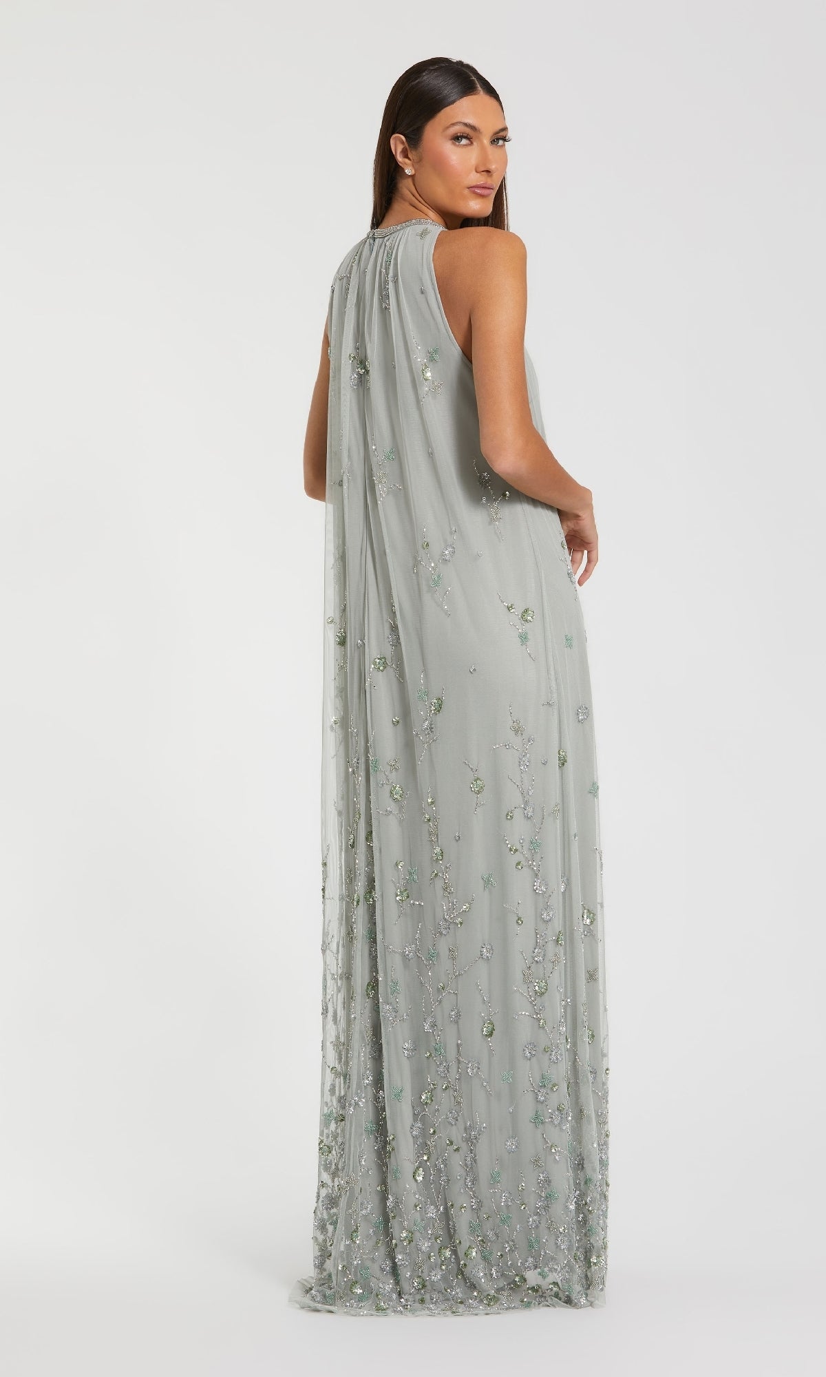 A woman models the Sage Green Long Formal Dress: Mac Duggal 9382, a floor-length sleeveless beaded trapeze gown with sequin embellishments, shown from the back against a plain white background.